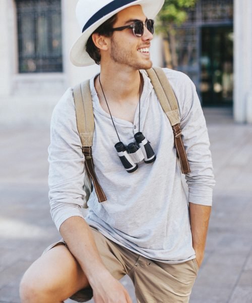 happy-young-tourist-posing-with-sunglasses (1)